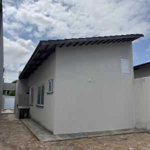 a white house with a black roof at Casa Sol Nascente in Aquiraz +8 photos
