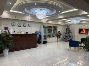 a store lobby with a christmas tree and a counter at Beksaroy in Samarkand +40 photos