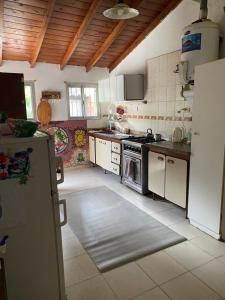 a kitchen with a refrigerator and a stove at Santa Tere in Santa Teresita