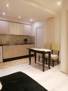 a kitchen with a table and chairs in a room at Guest House Plovdiv in Plovdiv