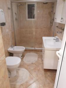 a bathroom with a toilet and a sink and a shower at Guest House Plovdiv in Plovdiv