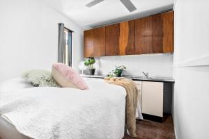 a bedroom with a bed and a kitchen at Melbourne suites - Zen Oasis or skyline views in Melbourne