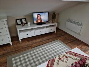 ein Wohnzimmer mit einem TV auf einer weißen Kommode in der Unterkunft Hrabovo Helena 19 in Ružomberok