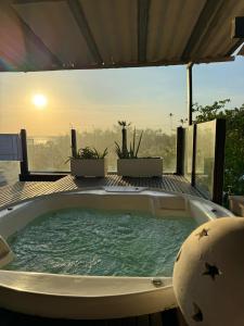 a jacuzzi tub on the deck of a house at Villa Puglia Jeri in Jericoacoara