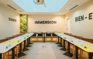 a large room with tables and chairs in it at ibis Styles Calais Centre in Calais