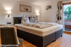 a bedroom with a large bed with pillows on it at Haus Panorama in Brixen im Thale