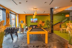 a living room with a ping pong table in it at ibis Styles Calais Centre in Calais