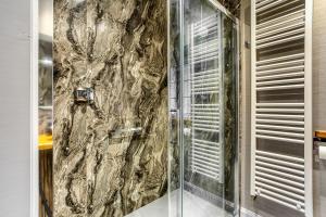 a shower with a glass door in a bathroom at Gate Lodge in Castle Douglas +10 photos
