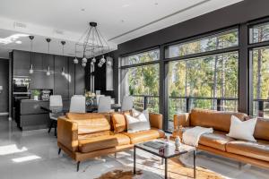 a living room with two couches and a dining room at Casa Pickala - The Luxury of life in Hovgård