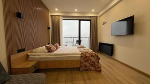 TV a/nebo společenská místnost v ubytování Gudauri Twins 404