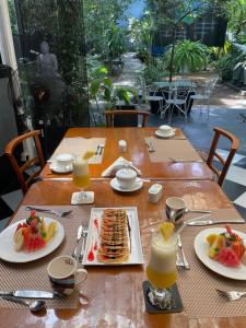 uma mesa de madeira com pratos de comida para o pequeno-almoço em Endlessblue Resort Kalametiya em Kalametiya