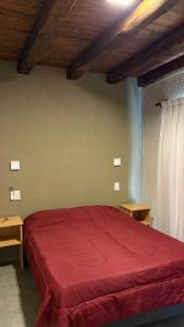 En eller flere senge i et værelse på El Atardecer Departamentos