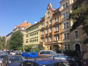 a parking lot with cars parked in front of buildings at Appartment Nezamyslova II in Prague