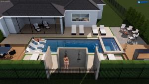 a model of a house with a woman standing in front of a pool at Double Rainbow Suites 24th in Fort Lauderdale