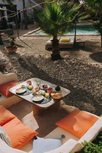 a tray of food on a table next to a pool at Les jardins de Silona, piscine chauffée in Essaouira