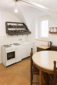 a kitchen with a stove and a table at Dimora Donato 2 bedrooms Lauco UD in Lauco