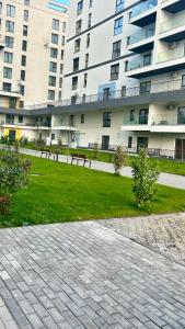 a park with benches in front of a building at Luxury Apartment private parking in Craiova