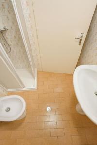 a bathroom with a sink and a toilet and a shower at Dimora Donato 2 bedrooms Lauco UD in Lauco +1 photo