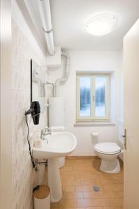 a white bathroom with a sink and a toilet at Dimora Donato 2 bedrooms Lauco UD in Lauco