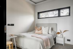 a bedroom with a bed and two windows at Casa Pickala - The Luxury of life in Hovgård