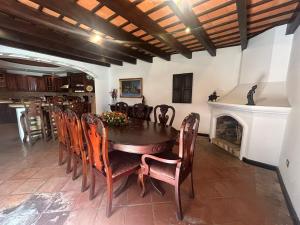 a dining room with a table and chairs and a fireplace at Lovely house in Antigua Guatemala for 7 guests in Cataltzul