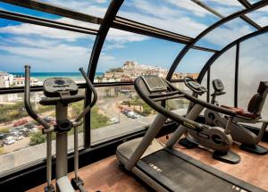 a gym with two cardio machines in a building at RH Don Carlos & Spa in Peniscola