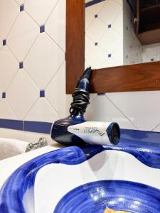a blue and white sink in a bathroom at ArtStay Apt Sempione, Near Metro, City Centre in Milan