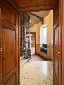 an entrance to a hallway with a door and a mirror at ArtStay Apt Sempione, Near Metro, City Centre in Milan