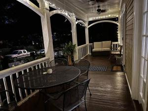 a patio with a table and chairs on a porch at Charming 3 bedroom Home in Decatur