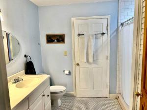 a bathroom with a white toilet and a sink at Charming 3 bedroom Home in Decatur