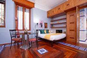 a bedroom with a bed and a table and chairs at ArtStay Apt Sempione, Near Metro, City Centre in Milan