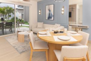a dining room and living room with a table and chairs at Brisas del Mar by Playa Caracol Resorts in Punta Chame
