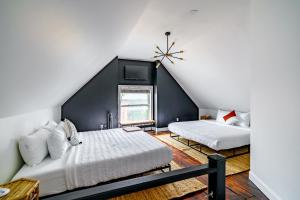 a bedroom with two beds and a window at Jungle House Luxury Homes - Columbus Downtown Short North - Steps to Convention Center & Nationwide Arena - Sleeps up to 10 - Free Parking - Over 5,800 Five Stars in Columbus