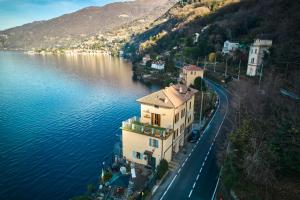 a large building on the side of a body of water at Casa Lago Como in Perledo