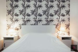 En eller flere senge i et værelse på Biscarrosse centre Duplex avec terrasse 6 personnes