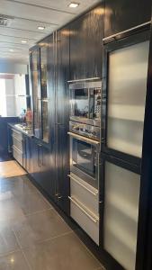 a kitchen with stainless steel appliances in a kitchen at Apartment luxurious a Hay Riad in Rabat