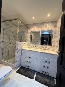 a bathroom with a sink and a shower at Apartment luxurious a Hay Riad in Rabat