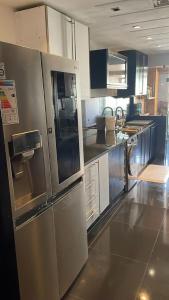 a kitchen with a large stainless steel refrigerator at Apartment luxurious a Hay Riad in Rabat
