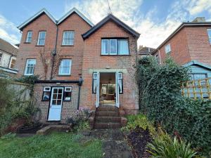 a brick house with a staircase leading to the front door at Thin End in Seaview