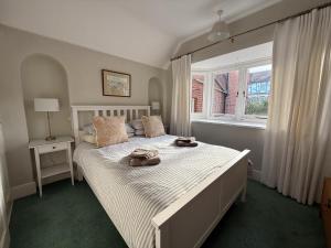 a bedroom with a large bed with two bags on it at Thin End in Seaview