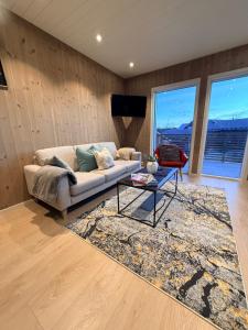 a living room with a couch and a table at KB - Nordic Luxury Rorbu in Stamsund