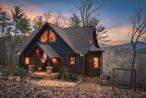 a log cabin in the woods at sunset at Mountain Views, Game Room, Firepit Near Wineries in Cleveland