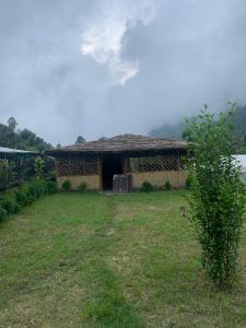 un pequeño edificio con una puerta en un patio en Oak Valley Camp, en Mussoorie