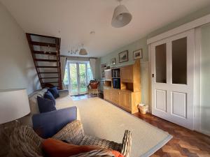 a living room with a stair case and a living room at Thin End in Seaview
