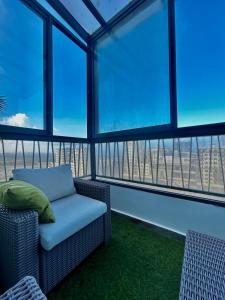 a room with a chair and large windows at Chic Cocoon & Impeccable Sea View in Zenata in Aïn Harrouda +55 photos