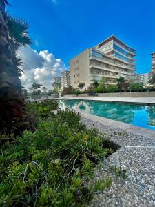 a swimming pool in front of a building at Chic Cocoon & Impeccable Sea View in Zenata in Aïn Harrouda