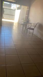 two benches in a room with a tile floor at Med House in Guaíra