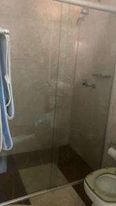 a bathroom with a glass shower with a toilet at Med House in Guaíra