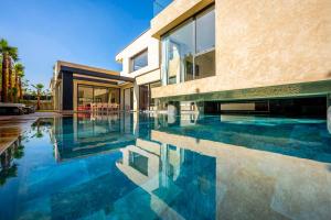 a swimming pool in front of a house at Palais Zahira in Marrakesh