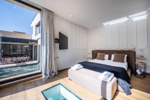 a bedroom with a bed and a large window at Palais Zahira in Marrakesh